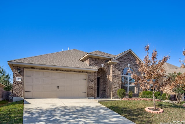 view of front of property featuring a front yard and a garage