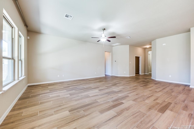 empty room featuring light wood-type flooring and ceiling fan