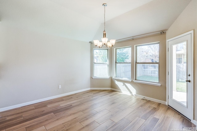 interior space with lofted ceiling and a notable chandelier