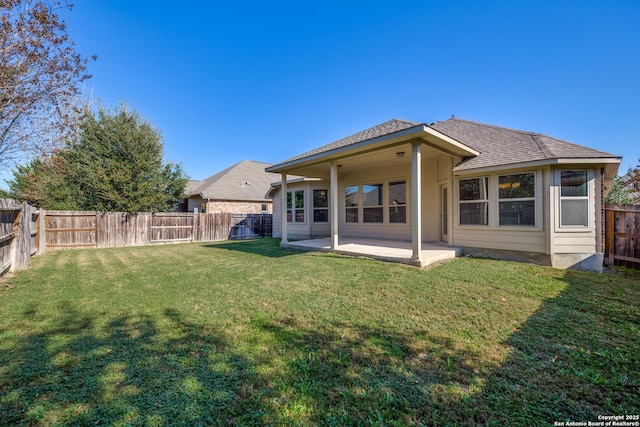 back of house with a yard and a patio area