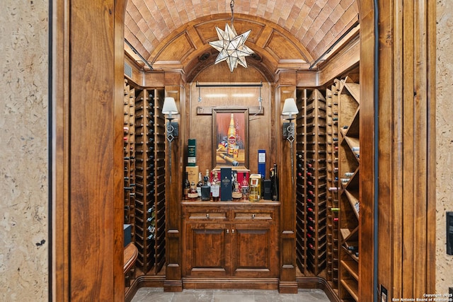 wine area with brick ceiling and lofted ceiling