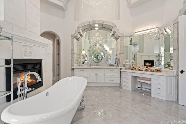 bathroom featuring a high ceiling, a washtub, and vanity