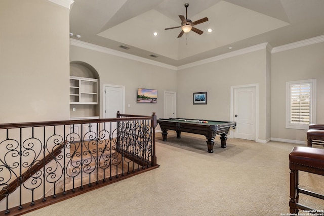 recreation room with a raised ceiling, pool table, and crown molding