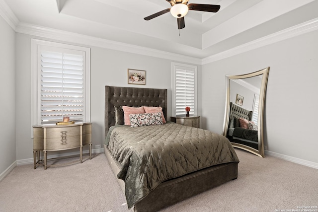 bedroom featuring ornamental molding, a raised ceiling, ceiling fan, and carpet flooring