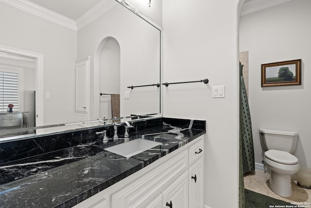 bathroom featuring toilet, ornamental molding, and vanity