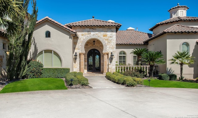 mediterranean / spanish house with a front lawn