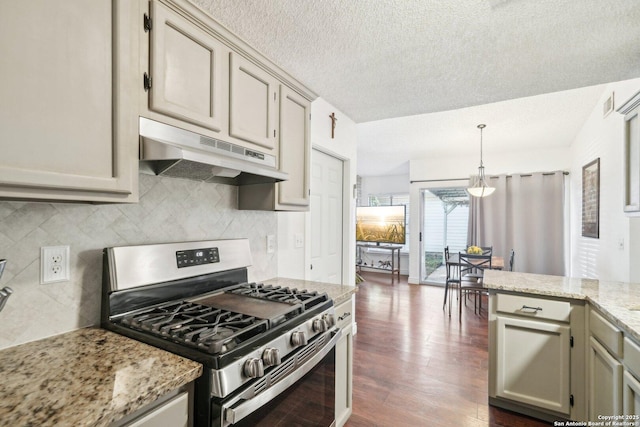 kitchen featuring a textured ceiling, stainless steel gas stove, light stone countertops, dark hardwood / wood-style flooring, and pendant lighting