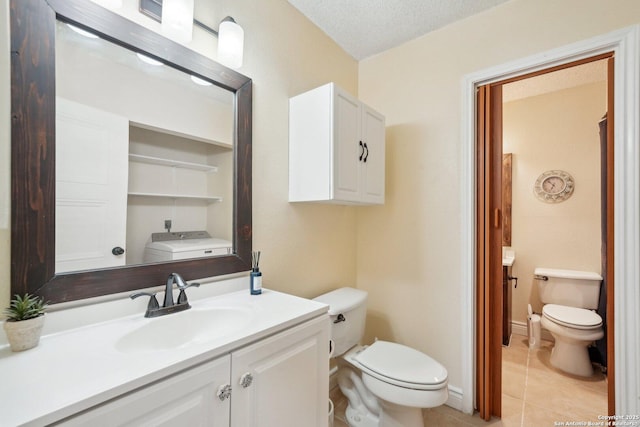 bathroom featuring toilet, tile patterned flooring, a textured ceiling, and vanity