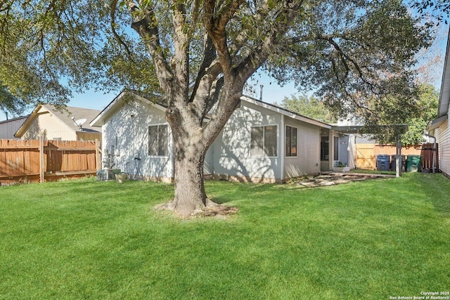 rear view of property featuring a lawn