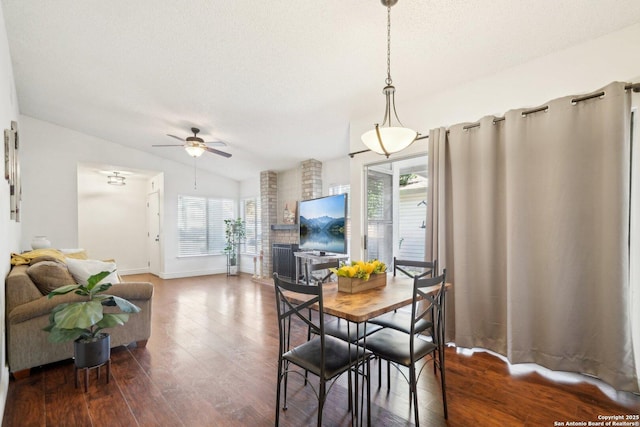 dining area featuring lofted ceiling, wood-type flooring, ceiling fan, and a wealth of natural light