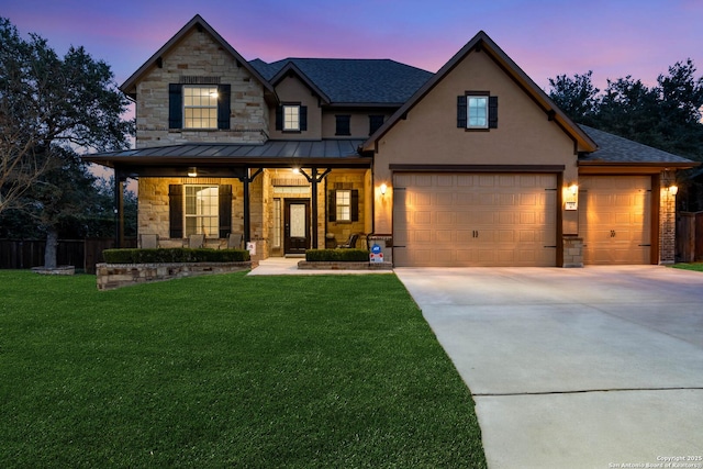 view of front of house with covered porch and a yard