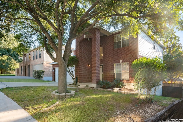 view of front of home with a front lawn and a garage