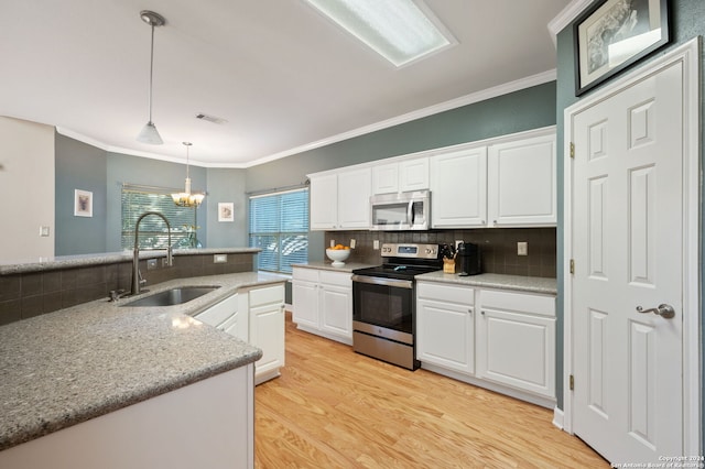 kitchen with stainless steel appliances, white cabinetry, and sink