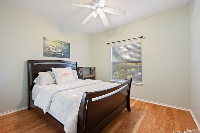 bedroom with ceiling fan and light hardwood / wood-style floors