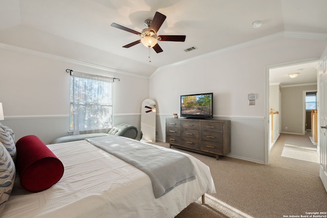 carpeted bedroom with ceiling fan, vaulted ceiling, and crown molding