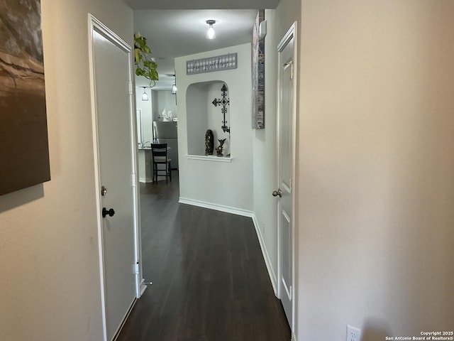 hallway with dark hardwood / wood-style floors