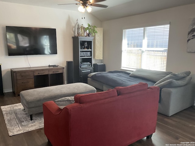 living room featuring ceiling fan and dark hardwood / wood-style flooring