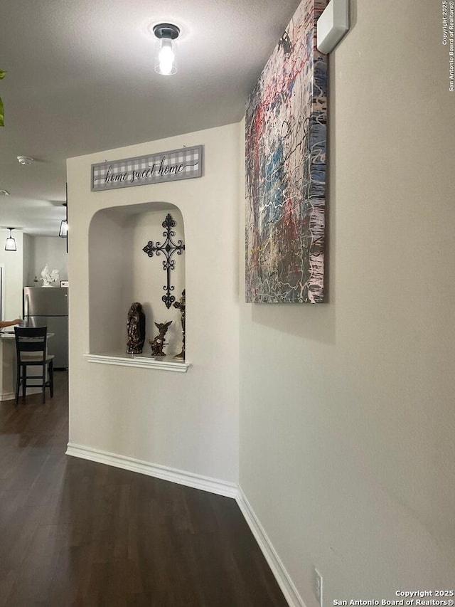 hallway featuring dark hardwood / wood-style flooring