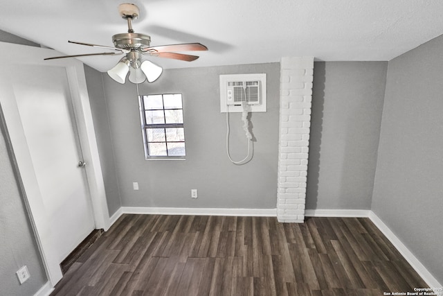 empty room featuring ceiling fan, a wall mounted air conditioner, and dark hardwood / wood-style flooring