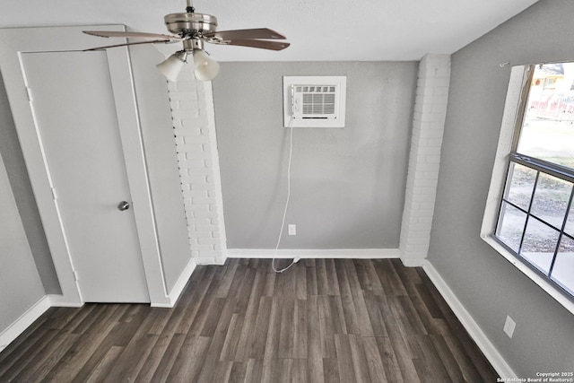 interior space with vaulted ceiling, dark wood-type flooring, a wall mounted AC, and ceiling fan