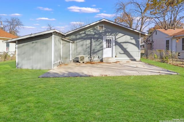 back of house featuring a lawn, ac unit, and a patio