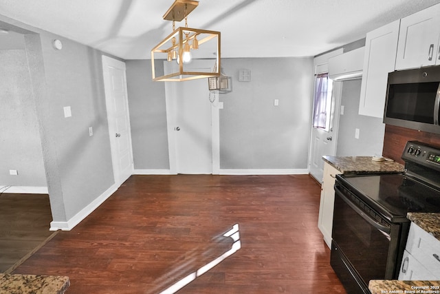 kitchen with decorative light fixtures, white cabinetry, dark stone countertops, electric stove, and dark wood-type flooring