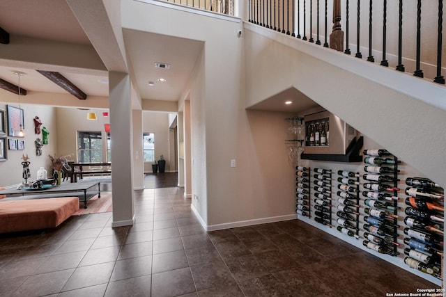 foyer entrance featuring beam ceiling