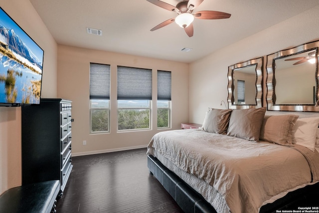 bedroom with ceiling fan and dark hardwood / wood-style flooring