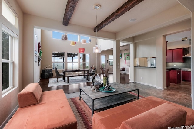 living room with beam ceiling and a healthy amount of sunlight