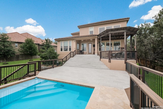 rear view of property featuring a patio area, a lawn, a fenced in pool, and a pergola