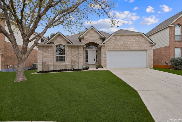 view of front of property with a front yard, a garage, and central air condition unit