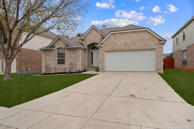 single story home with a front yard and a garage