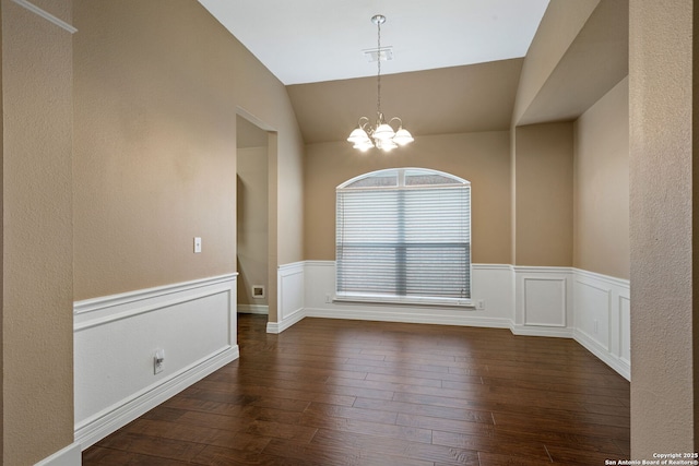 unfurnished room with vaulted ceiling, dark hardwood / wood-style flooring, and a chandelier