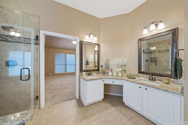 bathroom featuring tile patterned flooring, an enclosed shower, and vanity