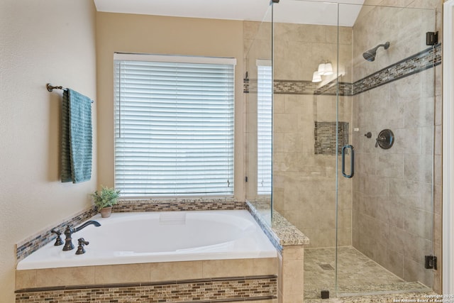 bathroom featuring shower with separate bathtub