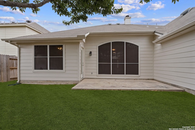 back of house featuring a yard and a patio