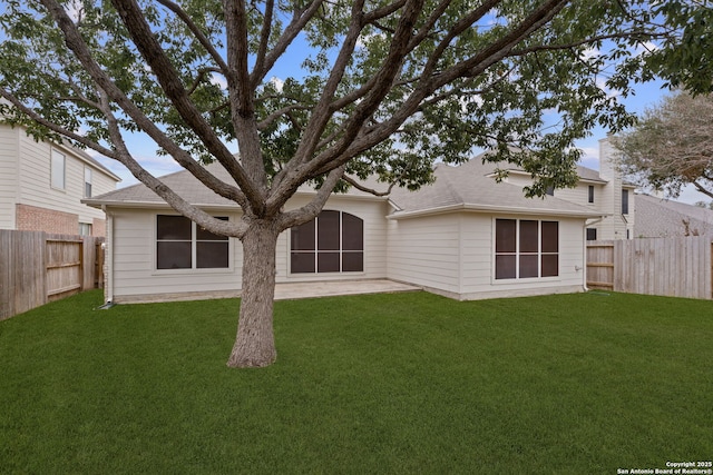 back of property featuring a yard and a patio