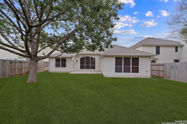 back of property featuring a patio and a yard