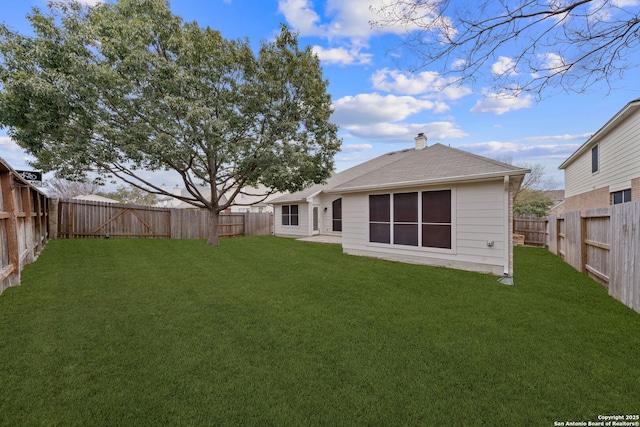 rear view of house featuring a yard