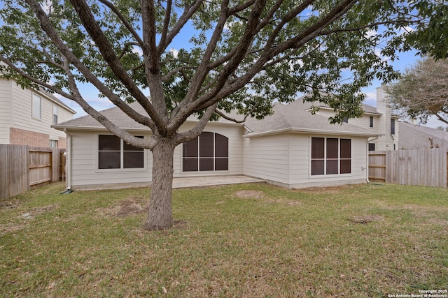 rear view of property with a patio area and a yard