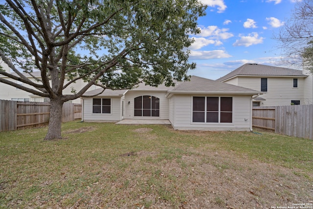 rear view of house with a patio area and a yard