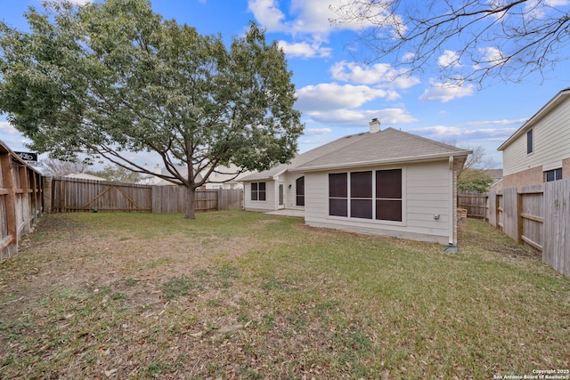 rear view of house with a yard