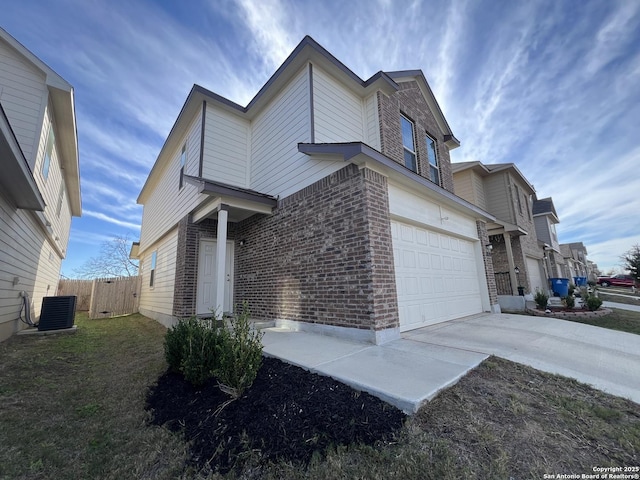 view of side of home with a garage and cooling unit