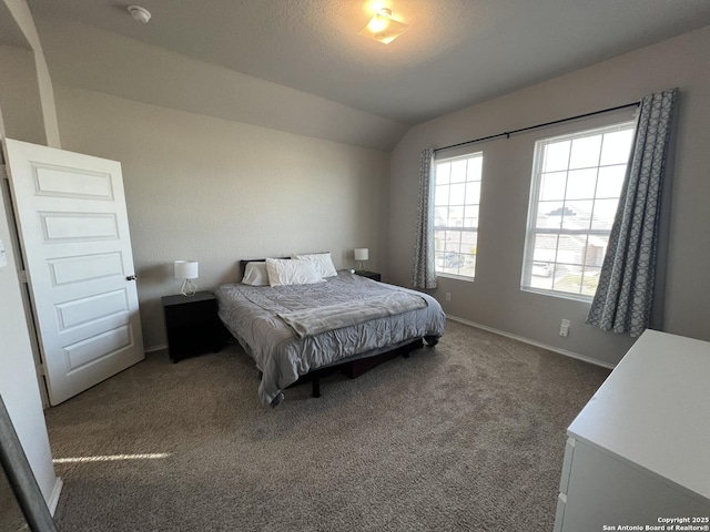 carpeted bedroom with lofted ceiling