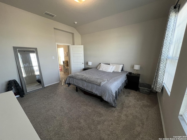 carpeted bedroom with vaulted ceiling