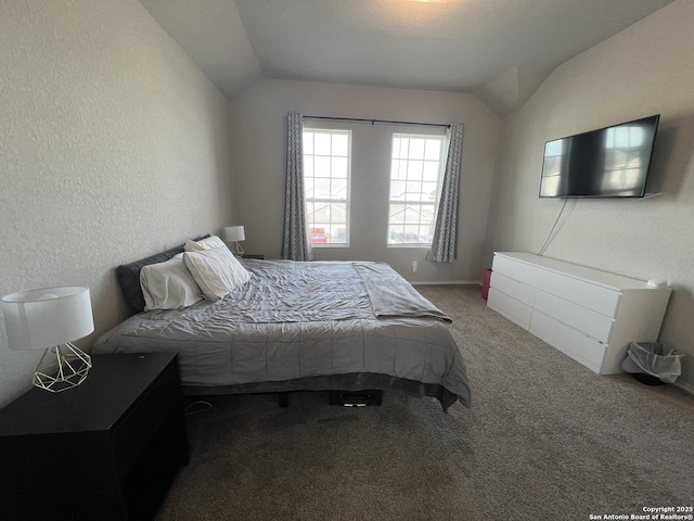 carpeted bedroom with lofted ceiling