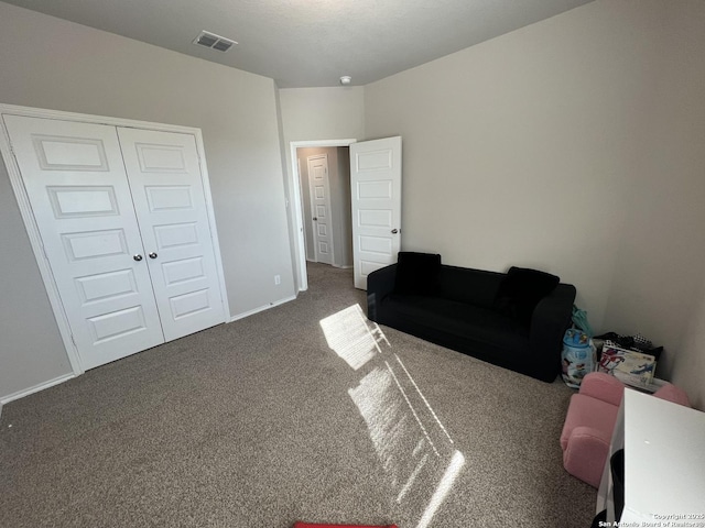 sitting room featuring dark carpet