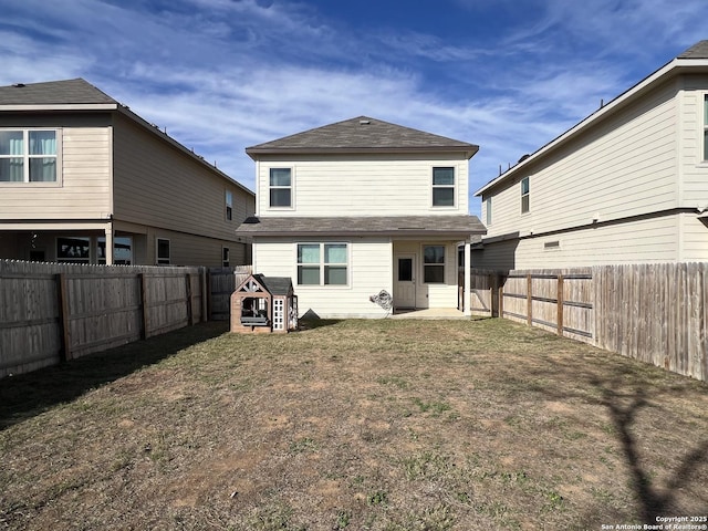 rear view of house featuring a lawn