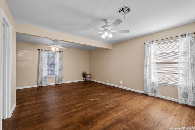 spare room with ceiling fan and dark hardwood / wood-style flooring