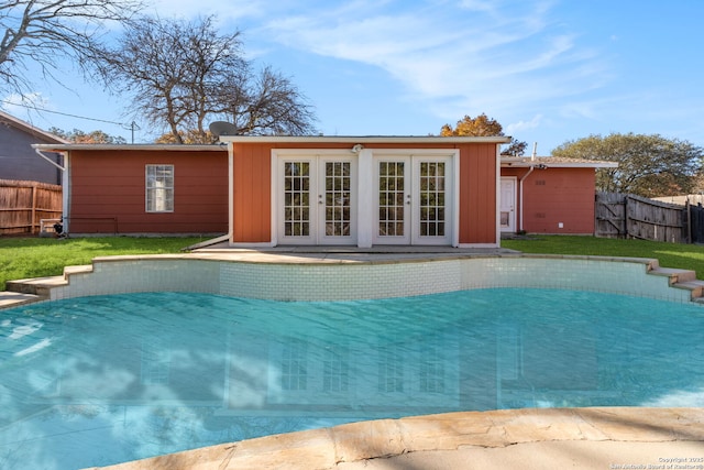 view of pool with a yard and an outdoor structure